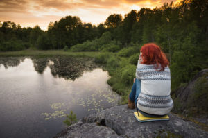 sitting on lake bank